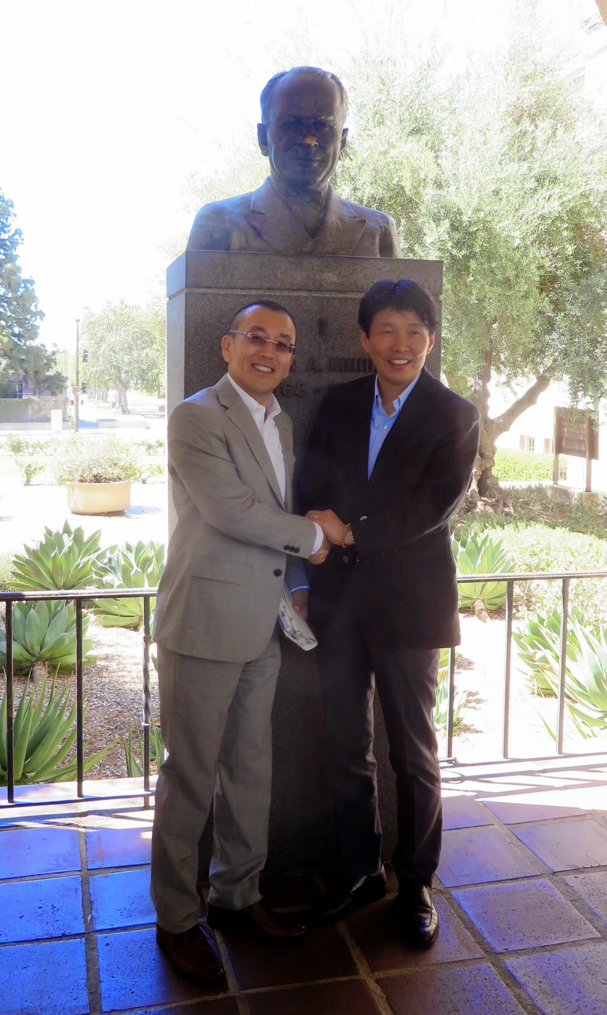 Minister Yamamoto and Prof. Ooguri in front of a bust of Robert Millikan, the Founding Director at Caltech.