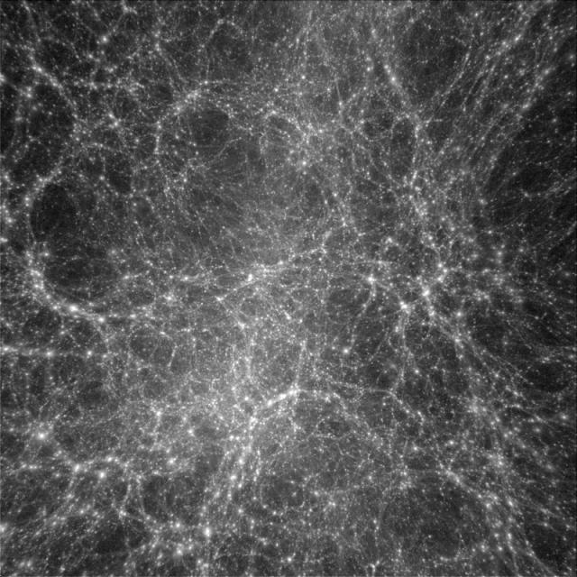 図３: コンピューターシミュレーションから得られた暗黒物質の分布。一辺がおよそ１億光年の領域の中での暗黒物質を表しており、図の明るい部分には暗黒物質が集中している。銀河はこのような高密度部にあると考えられる。